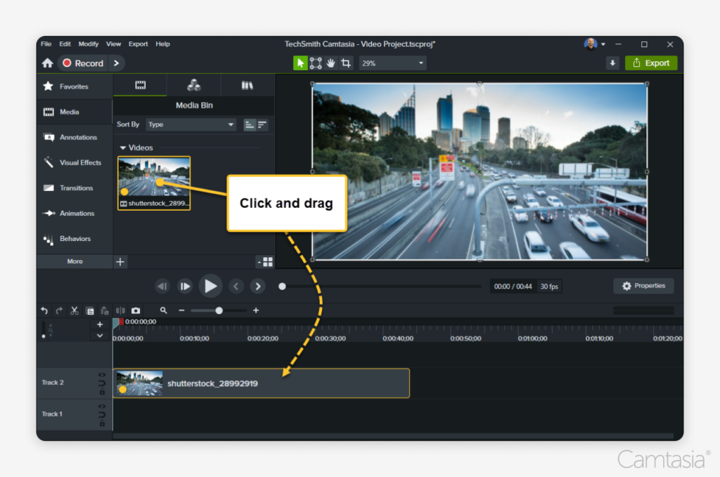 Image of the Camtasia editor instructing to click and drag a video onto the editing track.