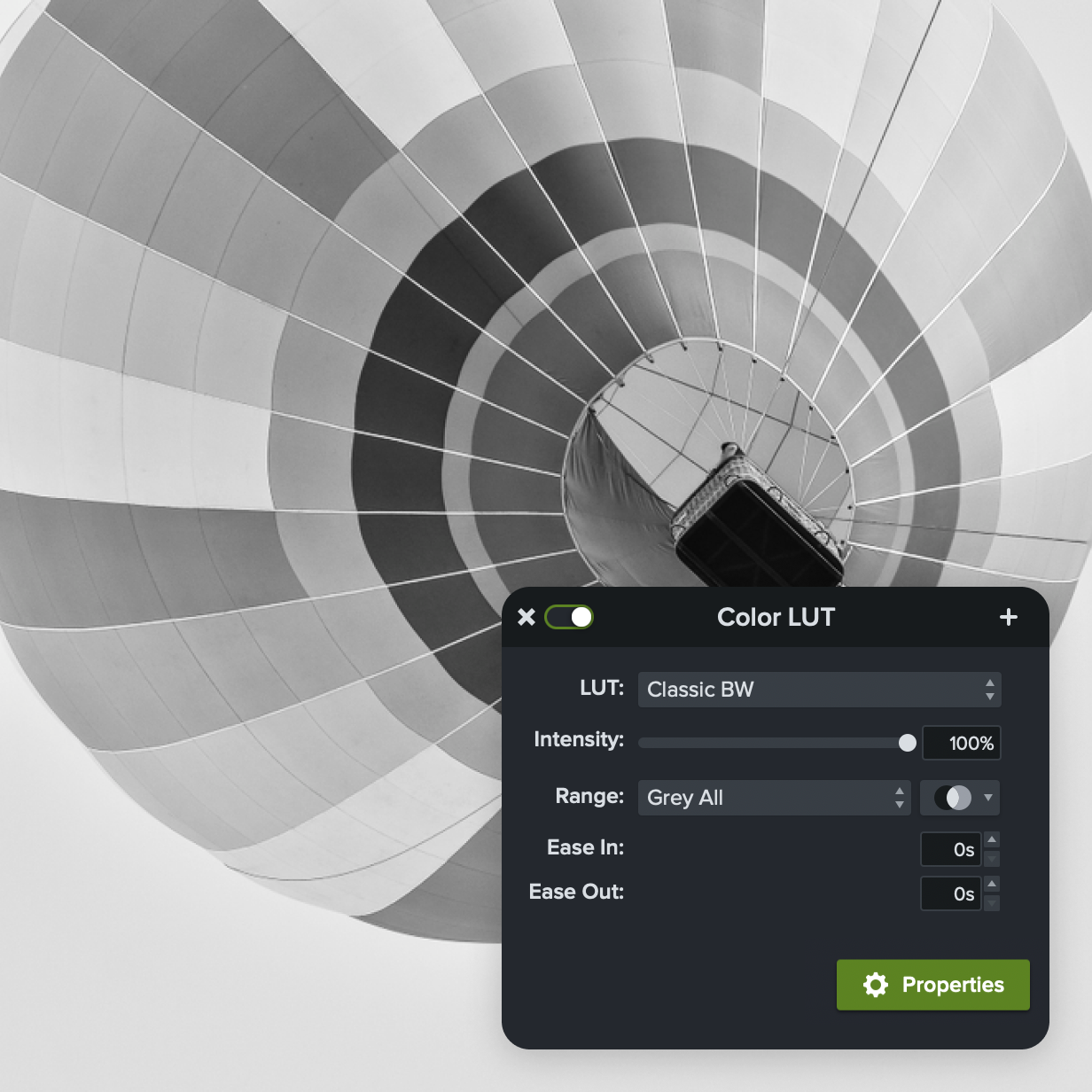 The image shows a black-and-white photo of a hot air balloon viewed from below, with a Color LUT settings panel overlaid. The panel is set to "Classic BW" with 100% intensity, affecting the entire range. Options for easing in and out are set to 0 seconds, and there is a button labeled "Properties."