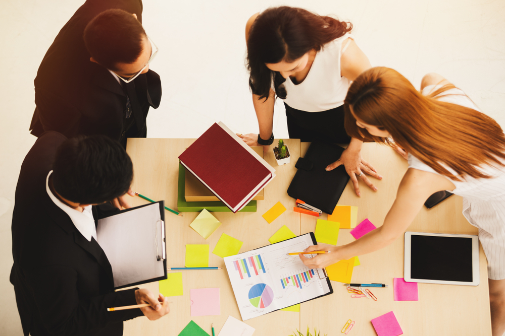 People at a meeting looking at visual representations. 